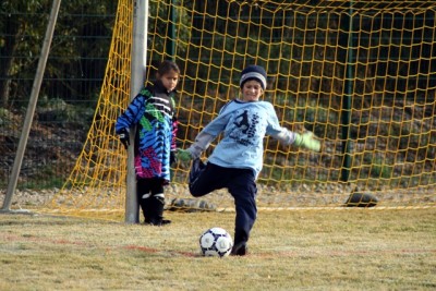 Kyle, our soccer star going for a big kick on a cold day in Germany.